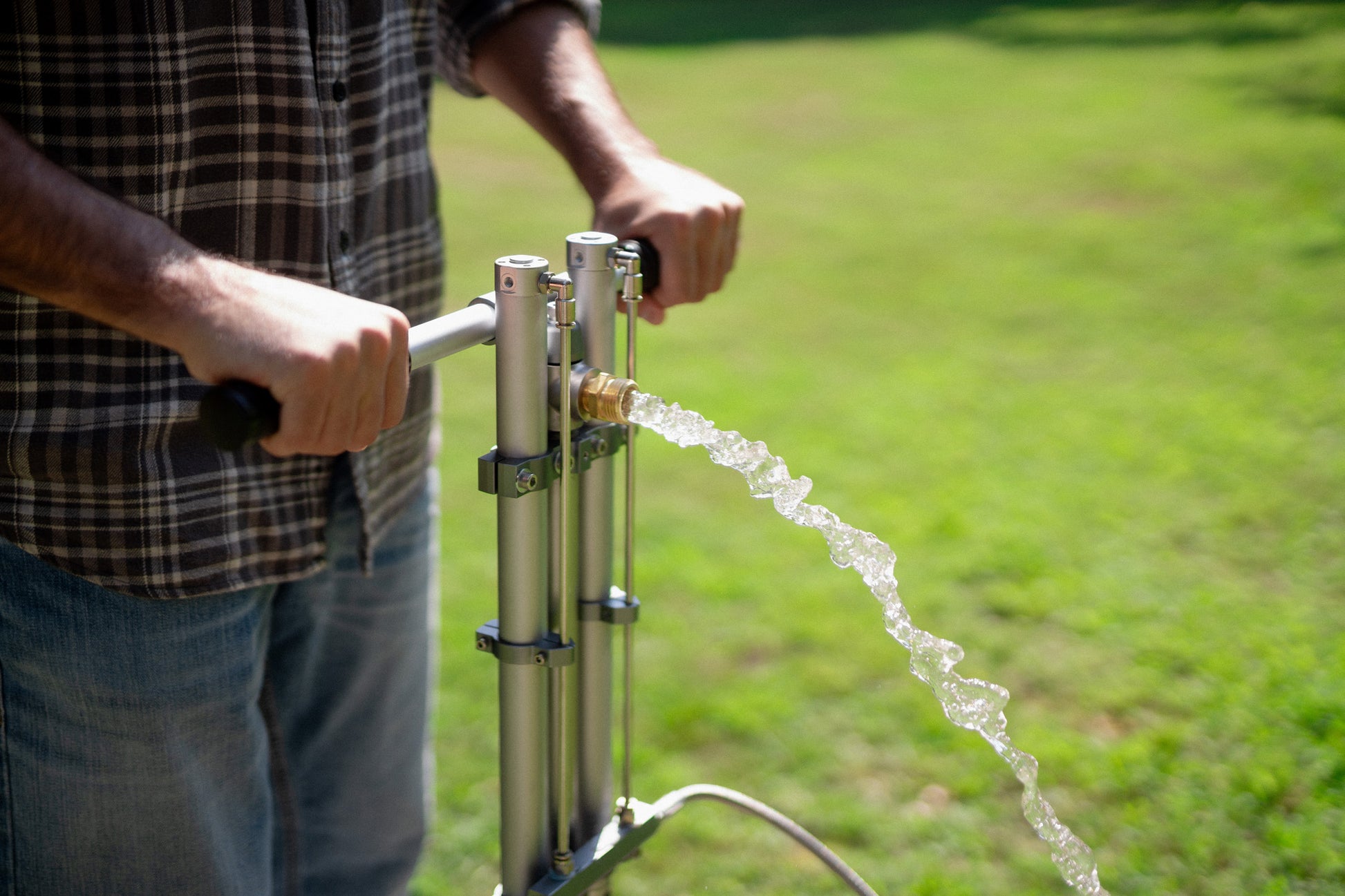 Drawing water with a Flojak Rigid backup hand well pump.